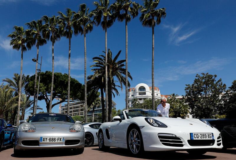 epa07553410 (FILE) - A visitor looks at cars on display during the 1st Porsche Festival in Cannes, 28 April 2019 (reissued 07 May 2019). German prosecutors have imposed a fine of 535 million euros on German luxury carmaker Porsche AG for neglecting supervisory obligations linked to diesel emissions cheating.  EPA/SEBASTIEN NOGIER