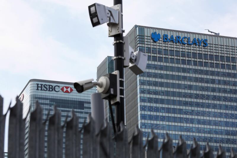 A security camera sits in view of the offices of HSBC Holdings Plc, left, and Barclays Plc, right, in the Canary Wharf business, financial and shopping district in London, U.K., on Thursday, June 5, 2018. The owners of a Canary Wharf skyscraper leased to Citigroup Inc. are seeking to refinance the 661 million-pound ($882 million) loan used to buy it five years ago, two people with knowledge of the plan said. Photographer: Chris Ratcliffe/Bloomberg