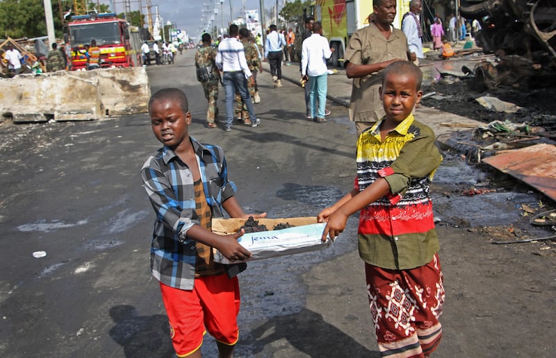 Somali children assist other civilians and security forces in  rescue efforts. Farah Abdi Warsameh / AP Photo