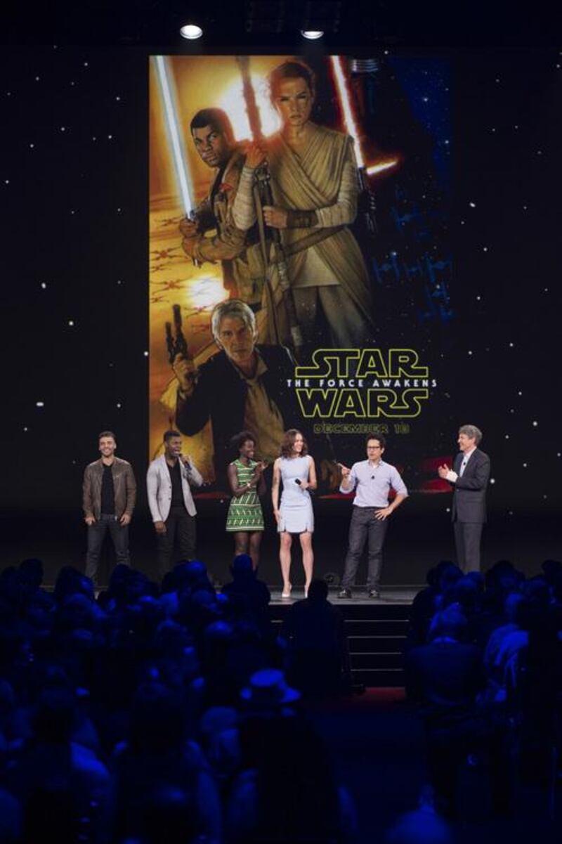The Force Awakens director JJ Abrams, second right, and cast with the first poster for the film at the D23 event. Disney / Image Group