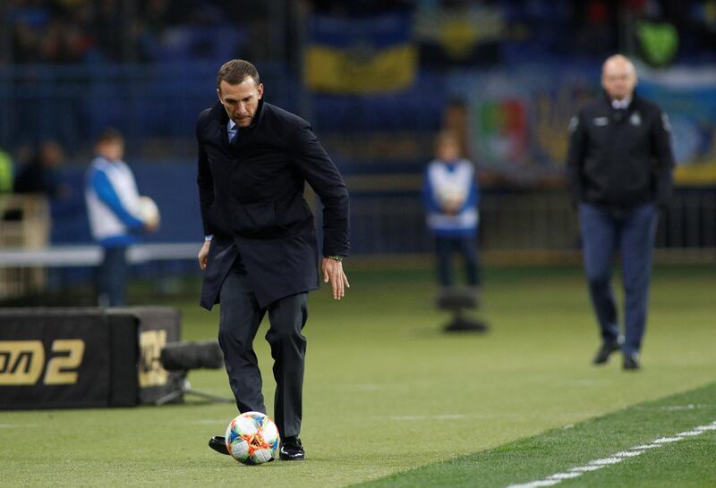 Ukraine coach Andriy Shevchenko kicks the ball after it goes out for a throw-in. Reuters