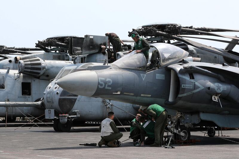 US Marines maintain aircraft on the flight deck.