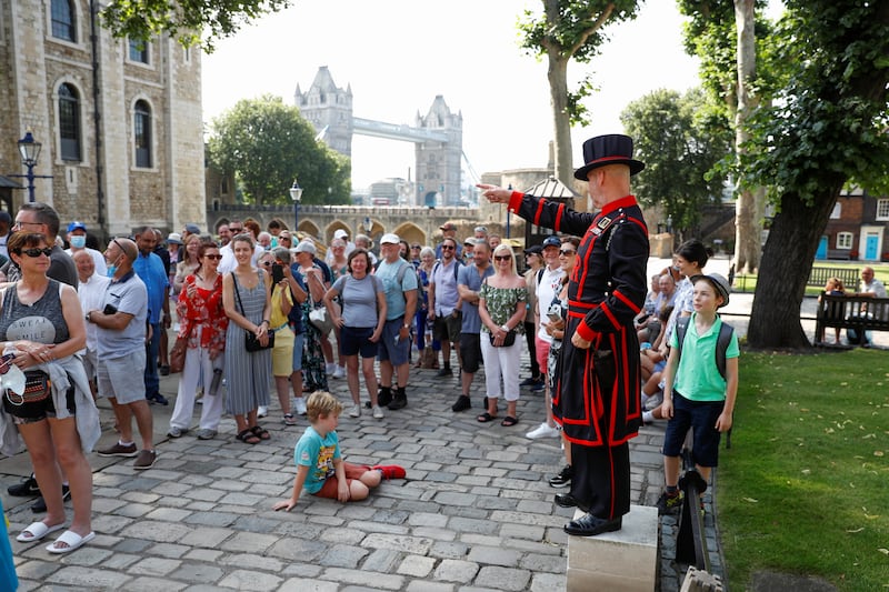 A Yeoman Warder gestures as he leads the first 'Beefeater' tour of the Tower of London in 16 months.