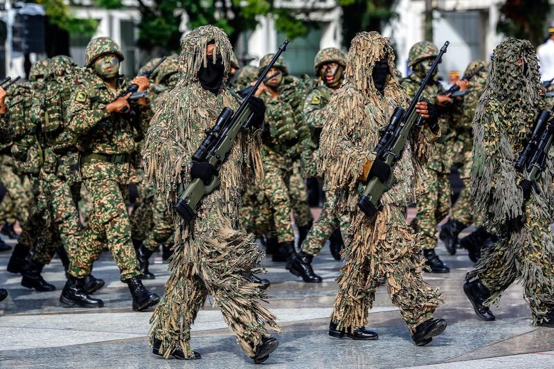 Malaysian armed forces personnel in camouflage suits march during an Independence Day celebration rehearsal in Putrajaya. EPA
