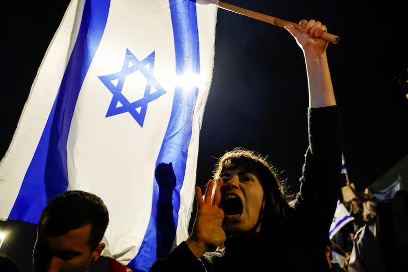 A protester shouts anti-government slogans in Jerusalem after Israel's Defence Minister was dismissed. Reuters