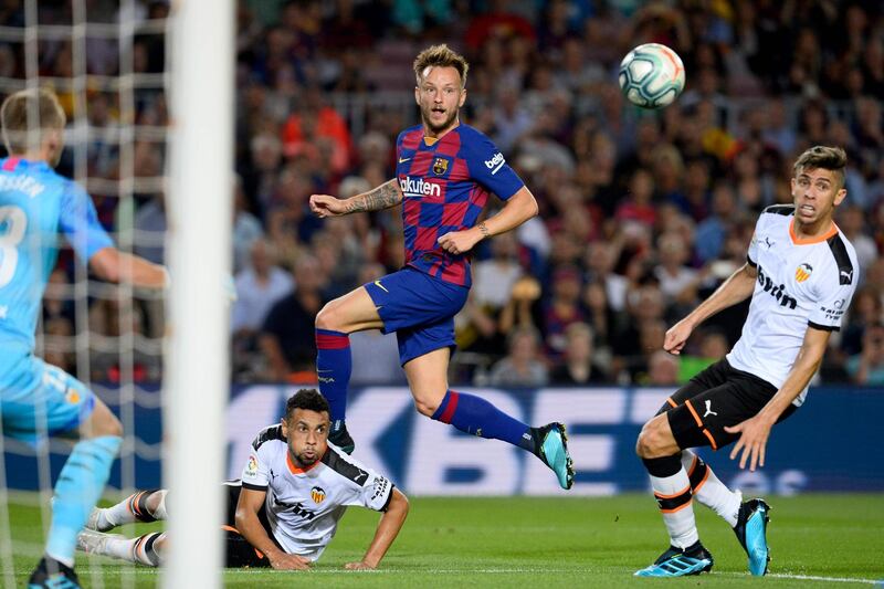 Barcelona's Croatian midfielder Ivan Rakitic eyes the ball. AFP