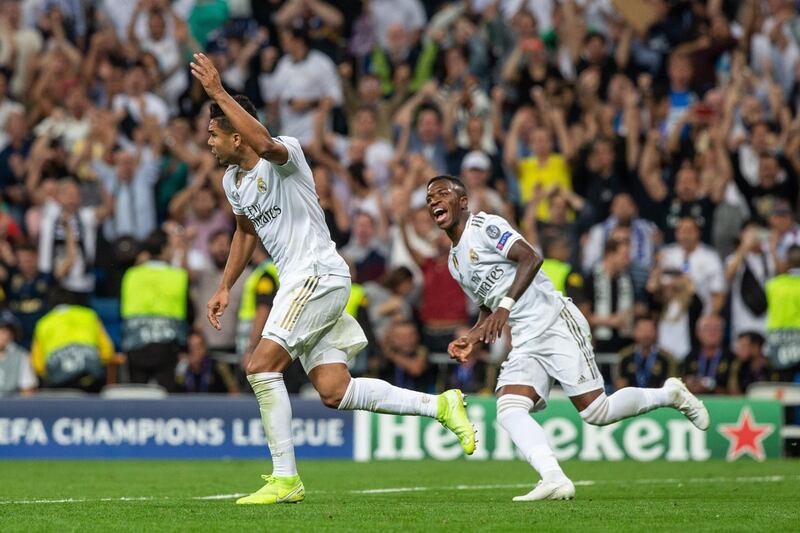 Real Madrid's midfielder Carlos Henrique Casemiro and Vinicius Jr (R) react during the UEFA Champions League group A match between Real Madrid and Club Brugge at Santiago Bernabeu in Madrid, Spain.  EPA