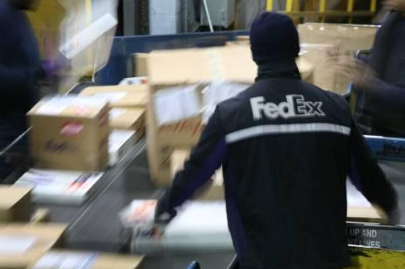 A FedEx worker sorts packages passing along a conveyor belt before loading them onto delivery trucks at the FedEx Express Station Monday, Dec. 15, 2008 in New York. The package delivery company, based in Memphis, Tenn., has its busiest day of the year Monday. (AP Photo/Mark Lennihan)