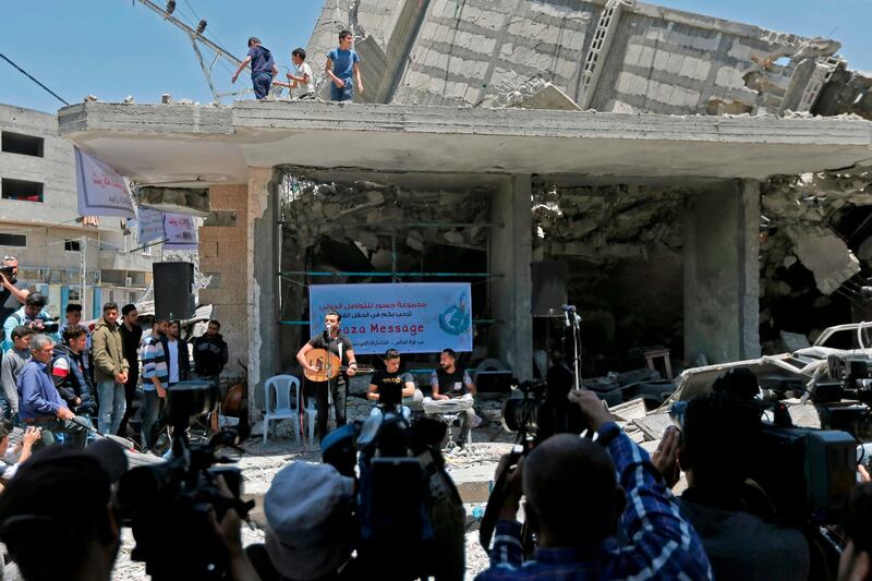 Palestinian journalists film as members of the band Dawaween perform  in Gaza City. AFP