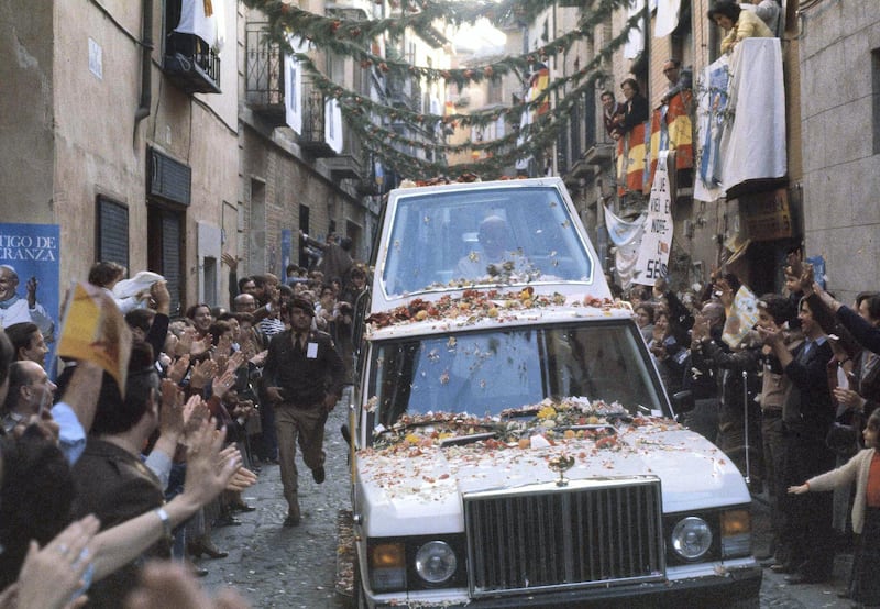 Pope John Paul II rides along a narrow street in his bullet-proof Popemobile in Toledo, Spain, Nov. 2, 1982. (AP Photo)