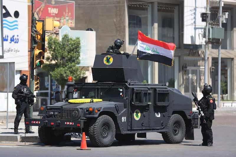 Members of the Iraqi Counter-terrorism Service (ICTS) are deployed in the streets of the capital Baghdad on March 27, 2021, days after a military parade by an armed faction loyal to Iran. On March 25, masked gunmen in a convoy of pick-ups drove through the Iraqi capital staging a show of force against Prime Minister Mustafa al-Kadhemi who has proposed a new dialogue with Washington.
Militants of the Rabaa Allah group brandished mocking portraits of the prime minister, who is seen as pro-American, and other government officials showing their faces trampled underfoot.
Rabaa Allah is the newest and most powerful of a myriad of pro-Iran groups in Iraq.
It is seen by experts as a cover for Kataeb Hezbollah which has been integrated into the Iraqi security forces, giving it leeway to oppose the official line.
 / AFP / AHMAD AL-RUBAYE
