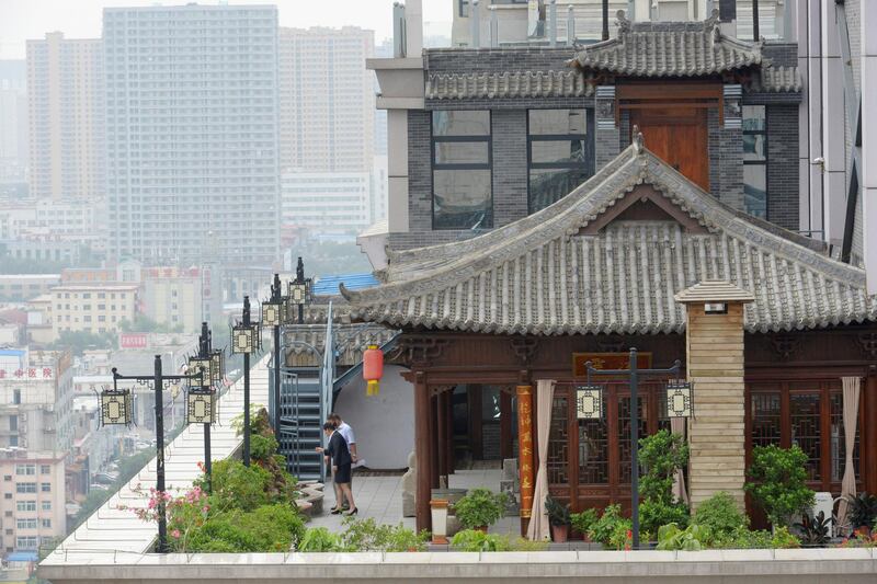 TAIYUAN, CHINA - AUGUST 07:  (CHINA OUT) Antique buildings are built on a rooftop of a tall building at Pingyang road on August 7, 2014 in Taiyuan, Shanxi province of China.  (Photo by VCG/VCG via Getty Images)