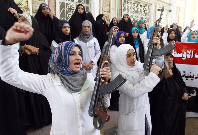Iraqi women in the southern Shiite Muslim shrine city of Najaf brandish weapons to show their willingness to join Iraqi security forces in the fight against militants who have taken over several northern Iraqi cities. Haidar Hamdani / AFP / June 18, 2014

