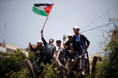 Palestinians climb over a tree during a rally marking International Workers' Day, or Labour Day, in Gaza City May 1, 2019. REUTERS/Mohammed Salem