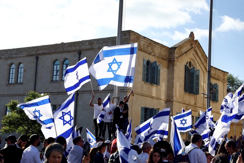 Right-wing protestors shout slogans as they fly national flags during a rally in Jerusalem. Reuters