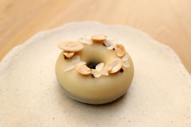 Angel Cakes serves a vegan donut with peanut praline and garnish that is also sugar and gluten-free
