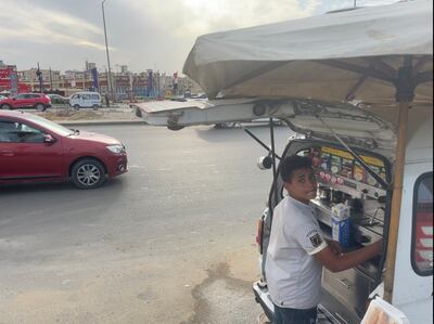 A coffee vendor makes coffee for a customer on a Cairo street. Kamal Tabikha / The National