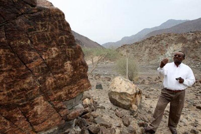 FUJAIRAH, UNITED ARAB EMIRATES – Jan 11,2011: Salah Ali Hassan, Head Archeologist of Fujairah Museum & Rock Art explaining about the ancient drawings on one of the rock (left side) at Wadi Sahm in Fujairah.  (Pawan Singh / The National) For News. Story by Rym