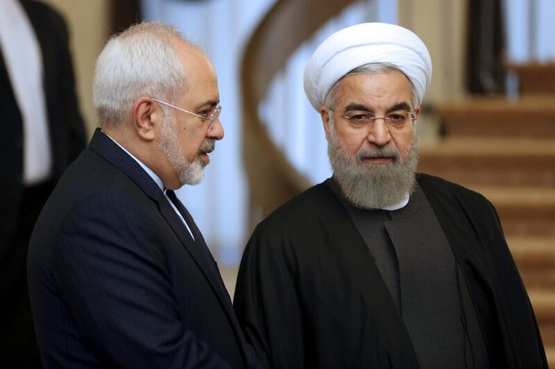 FILE - In this Nov. 24, 2015, file photo, Iranian President Hassan Rouhani, right, listens to his Foreign Minister Mohammad Javad Zarif prior to a meeting in Tehran, Iran. Rouhani is planning to make his first official visit to Iraq Monday, March 11, 2019, as he faces mounting pressure from hard-liners at home in the wake of the unravelling of the nuclear deal under the Trump administration. (AP Photo/Vahid Salemi, File)