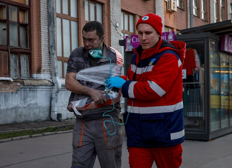 A medical worker helps a survivor of the strike in Kyiv. Reuters
