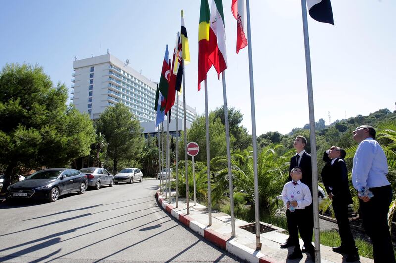 People look at flags ahead of the OPEC Ministerial Monitoring Committee in Algiers, Algeria. Reuters