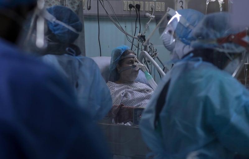 Members of the clinical staff wearing Personal Protective Equipment (PPE) care for a patient with coronavirus in the intensive care unit at the European Hospital, east of Rafah town, southern Gaza strip, 30 November 2020. The European Hospital, which has been classified as the Epidemiology Hospital since the start of the coronavirus in the Gaza Strip on 25 August 2020, has 334 infected cases under clinical care including 109 severe and critical cases. The production capacity of oxygen is 2,200 liters per minute, and there has become a large deficit after the increasing number of infections with Coronavirus.  EPA/MOHAMMED SABER