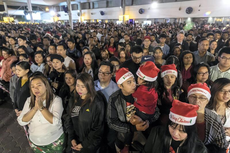 DUBAI, UNITED ARAB EMIRATES. 25 DECEMBER 2019. Midnight Mass at St Mary’s in Dubai to celebrate Christmas. People stand patiently during the ceremony. (Photo: Antonie Robertson/The National) Journalist: None. Section: National.
