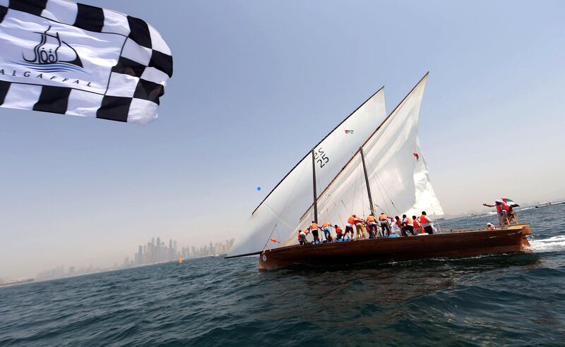 The crew of Zilzal, a dhow captained by Sheikh Hamdan bin Mohammad bin Rashid al-Maktoum, sails towards the finishing line off the coast of Dubai to win al-Gaffal traditional long-distance dhow sailing race which started at the island of Sir Bu Nair in the Gulf, on May 14, 2017. / AFP / Karim SAHIB
