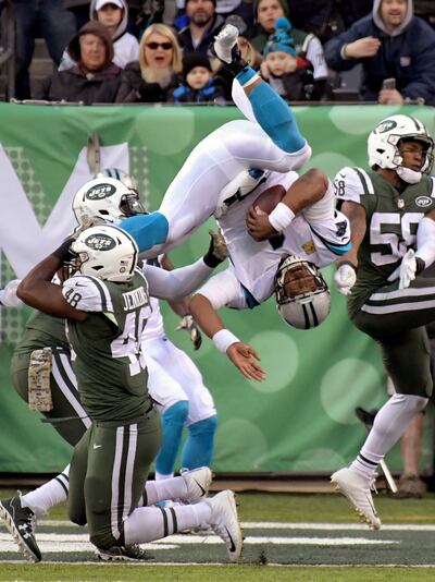 Carolina Panthers quarterback Cam Newton (1) dives over a tackle-attempt by New York Jets outside linebacker Jordan Jenkins (48) on a two-point conversion during the second half of an NFL football game, Sunday, Nov. 26, 2017, in East Rutherford, N.J. (AP Photo/Bill Kostroun)