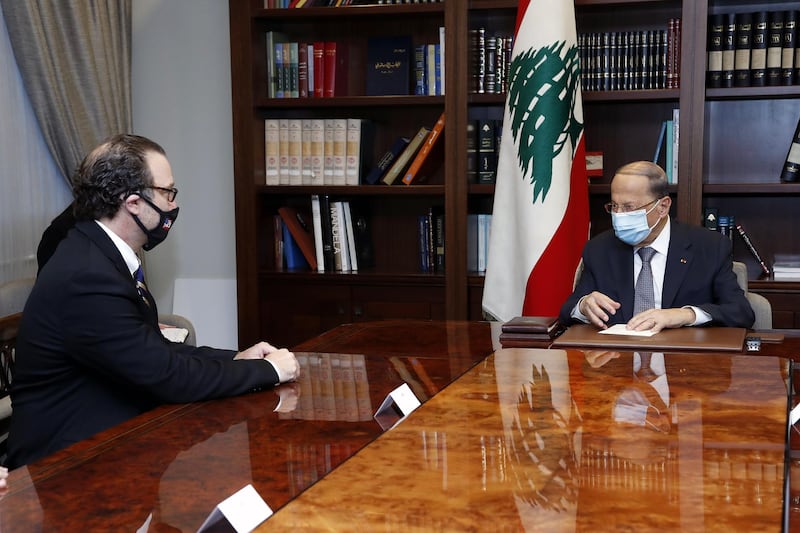 In this photo released by Lebanon's official government photographer Dalati Nohra, Lebanese President Michel Aoun, right, meets with U.S. Assistant Secretary of State for Near Eastern Affairs David Schenker at the Presidential Palace in Baabda, east of Beirut, Lebanon, Friday, Oct. 16, 2020. (Dalati Nohra/Lebanese Government via AP)