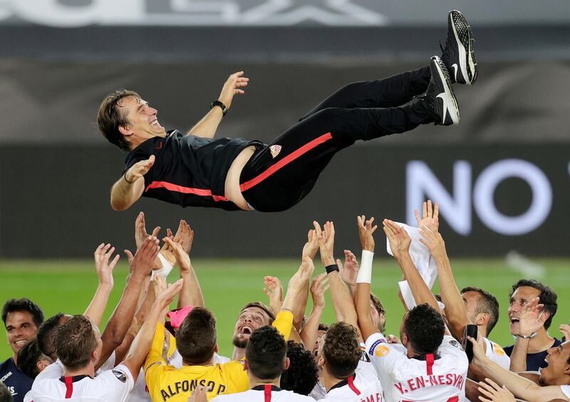 Sevilla coach Julen Lopetegui is thrown in the air by his players. Reuters