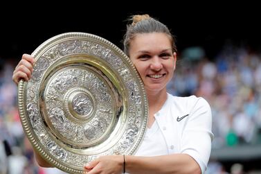 Tennis - Wimbledon - All England Lawn Tennis and Croquet Club, London, Britain - July 13, 2019 Romania's Simona Halep poses with the trophy as she celebrates after winning the final against Serena Williams of the U.S. Ben Curtis/Pool via REUTERS