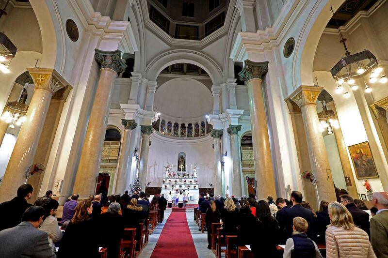 Worshippers attend the midnight Christmas Eve mass at Saint Joseph's Roman Catholic Church in the Egyptian capital Cairo in the central downtown district.  AFP