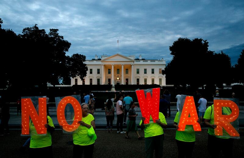 Protesters hold signs spelling out, "No War," outside the White House, Thursday June 20, 2019, in Washington, after President Donald Trump tweeted that "Iran made a very big mistake" by shooting down a U.S. surveillance drone over the Strait of Hormuz in Iran. (AP Photo/Jacquelyn Martin)