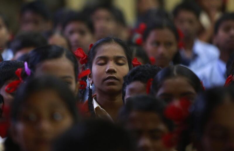 India schoolgirls in Mumbai offer prayers for victims killed in a Taliban attack on a military-run school in Peshawar. Rafiq Maqbool / AP Photo