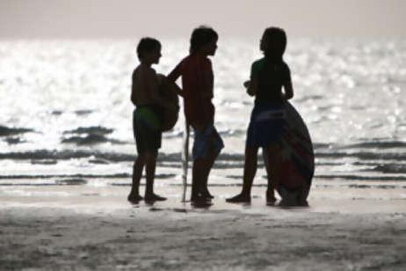 Children on Jumeirah public beach in Dubai.