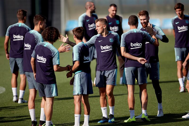 epa06899738 FC Barcelona's French defender Lucas Digne (C) is greeted by his team mates on the occasion of his 25th birthday during a training session held at Joan Gamper sports city in Barcelona, northeastern Spain, 20 July 2018. Spanish Primera Division League will kick off on the upcoming 18 August.  EPA/Alejandro Garcia