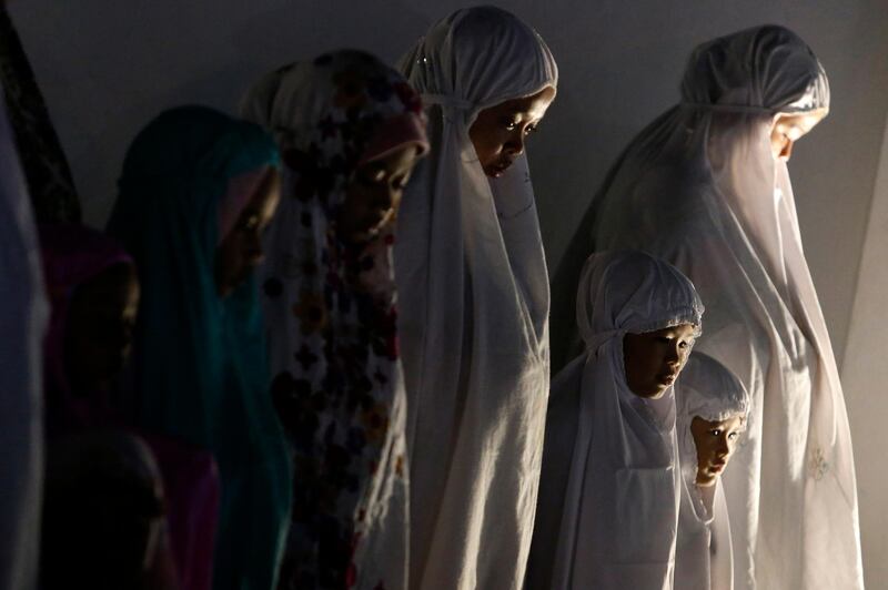 Indonesian Muslim women performing an evening prayer.  EPA