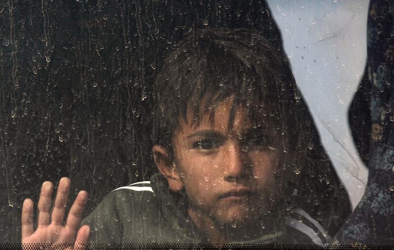 An Iraqi boy sits in a bus transporting displaced families from a displaced persons camp in Habbaniyah in Iraq's Anbar province. AFP