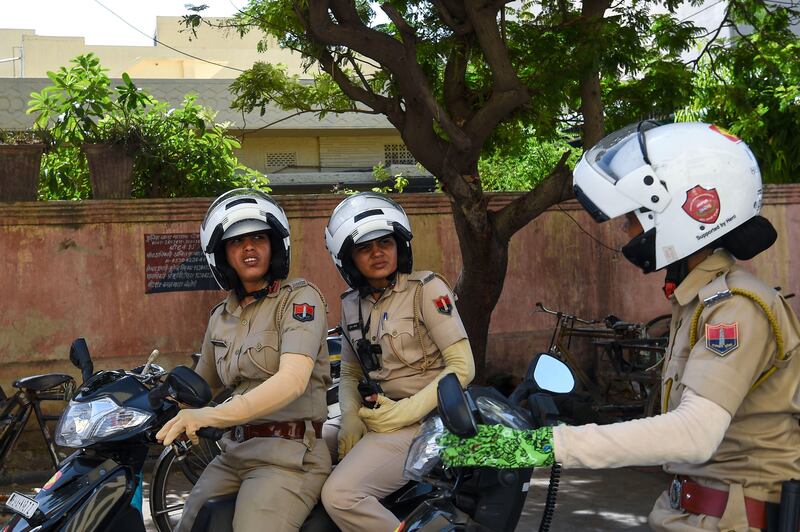 In this photo taken on June 14, 2017, members of a newly launched female police patrol unit drive through the old city in Jaipur.
All-female police units are shaking up the male-dominated force in conservative northwest India, hitting the streets to combat sex crimes and a pervasive culture of silence around rape. / AFP PHOTO / CHANDAN KHANNA / TO GO WITH India-social-crime-women,FEATURE by Abhaya SRIVASTAVA
