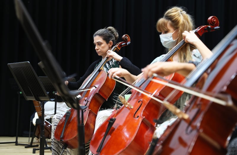 Elham Marzooqi (C) from UAE playing cello during the rehearsing of Firdaus Orchestra at the Gems Wellington school in Dubai.