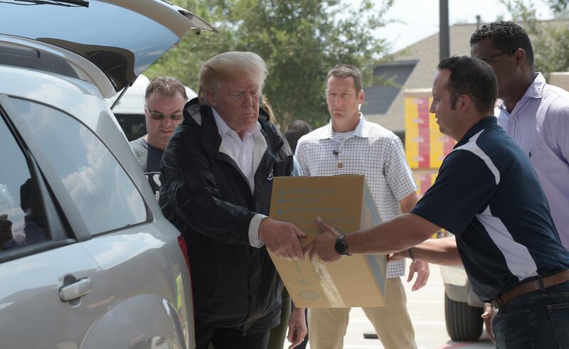 
                  President Donald Trump helps load donated items for people impacted by Hurricane Harvey during a visit to First Church of Pearland in Pearland, Texas, Saturday, Sept. 2, 2017. (AP Photo/Susan Walsh)
               