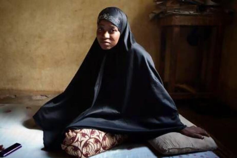 Lalla Arby, 22, who was beaten by Islamist group Ansar Dine for sitting outside her home in Timbuktu with her head uncovered, poses for a picture wearing a headscarf of the type residents of the north are now forced to wear.