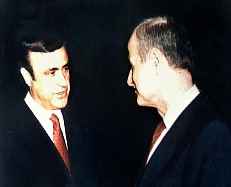 (FILES) A file picture shows Syrian President Hafez Assad (R) with his younger brother, Rifaat, taken at a formal reception in 1986. Syrian security forces fired shots and arrested guards who resisted as they closed down an "illegal" port run by the president's brother in the northern Mediterranean port of Latakia, Lebanese newspapers reported 21 October 1999. (Photo by AFP FILES / AFP)