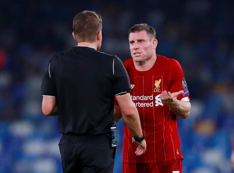 Liverpool's James Milner speaks with referee Felix Brych. Reuters