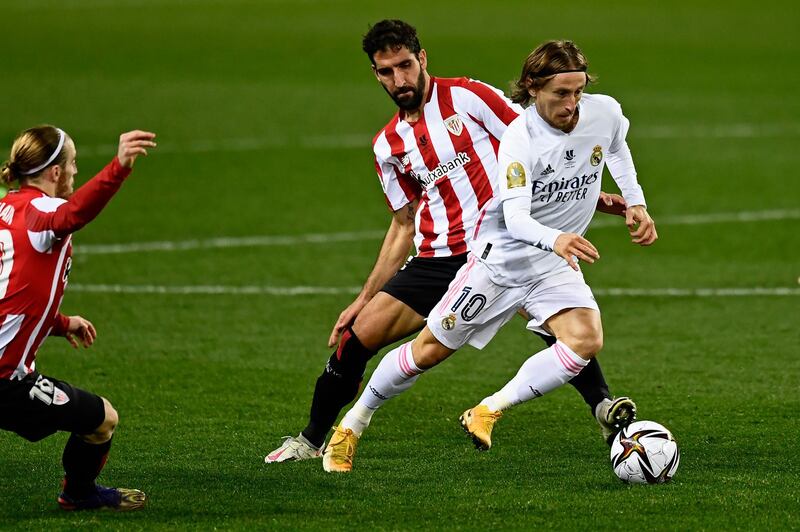 Real Madrid's Luka Modric, right, vies for the ball with Athletic Bilbao's Raul Garcia. AP