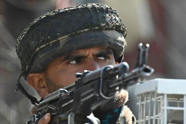 A Indian paramilitary trooper stands guard in Srinagar, the main city in the India-controlled portion of Kashmir, after an attack on police on February 19, 2021. AFP