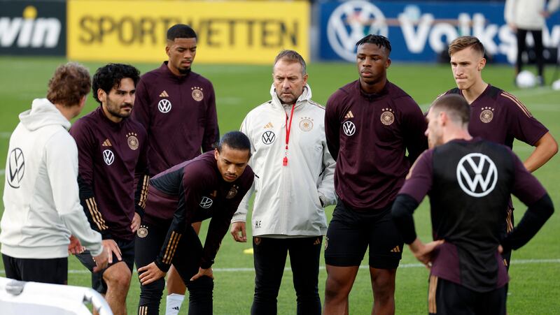 Germany coach Hansi Flick speaks to his players. Reuters