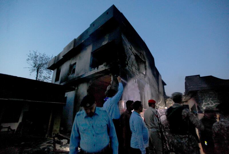 Army troops and police officers gather at the site of a plane crash in Rawalpindi. AP Photo