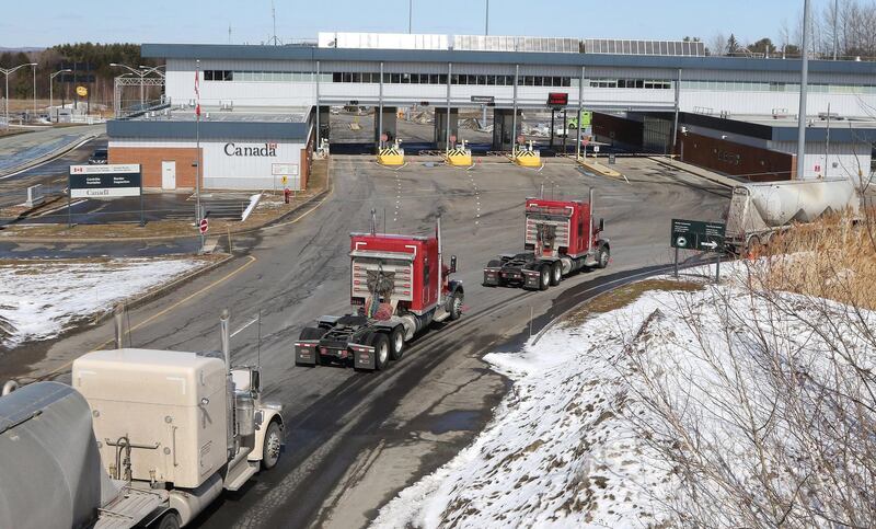 Vehicles are lined up at the US-Canada border in Derby, Vermont on March 18, 2020. Earlier in the day, US President Donald Trump and Canadian Prime Minister Justin Trudeau announced that the border would be closed to non-essential traffic. EPA